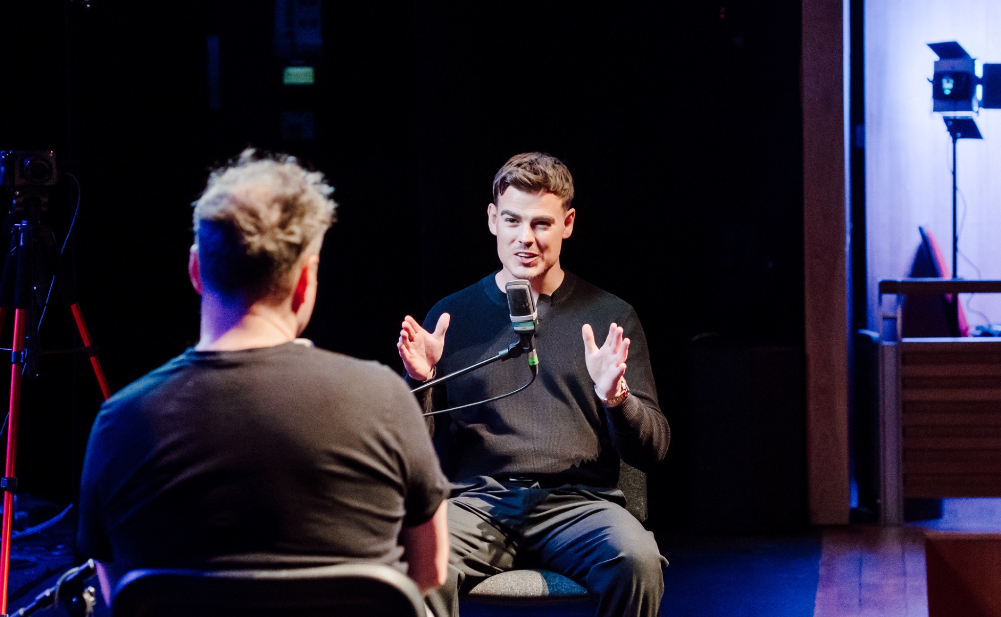 James Blake on stage at podcast event
